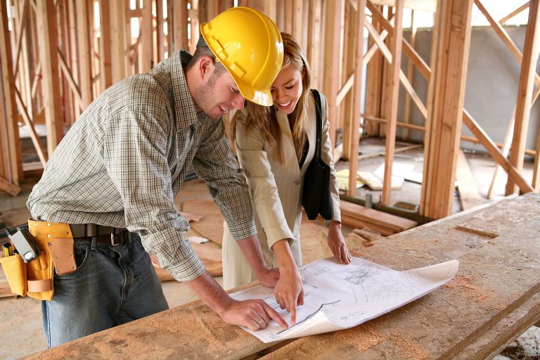 Homeowner and general contractor reviewing and discussing contract