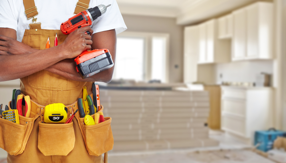general contractor for home repairs standing with tools