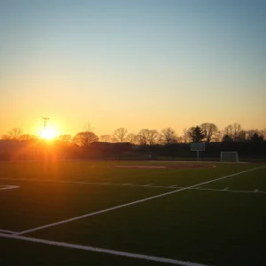 Empty lacrosse field with fading sunlight at dusk.