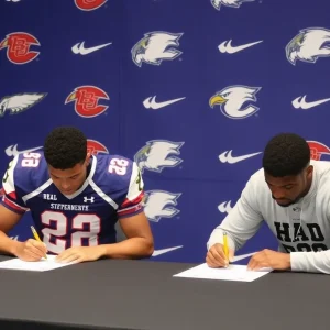 Football recruits signing documents with college logos in background.